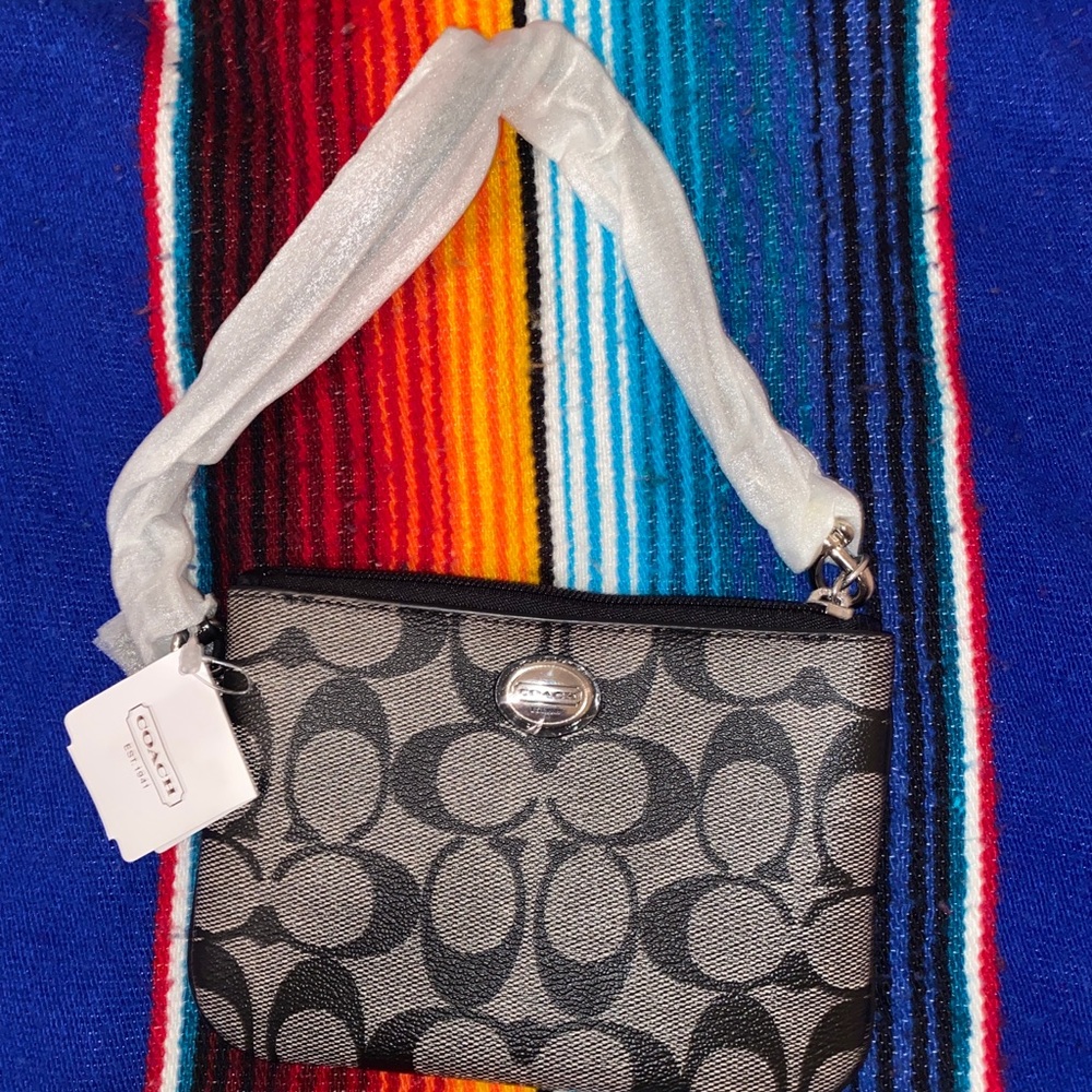 Small, black canvas Coach wristlet